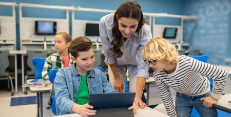 woman-two-students-looking-tablet